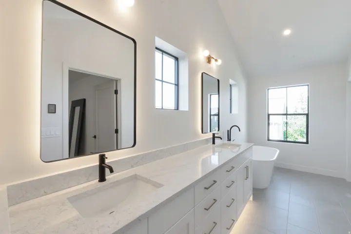 Dual vanity featuring light-colored countertops and undermount sinks