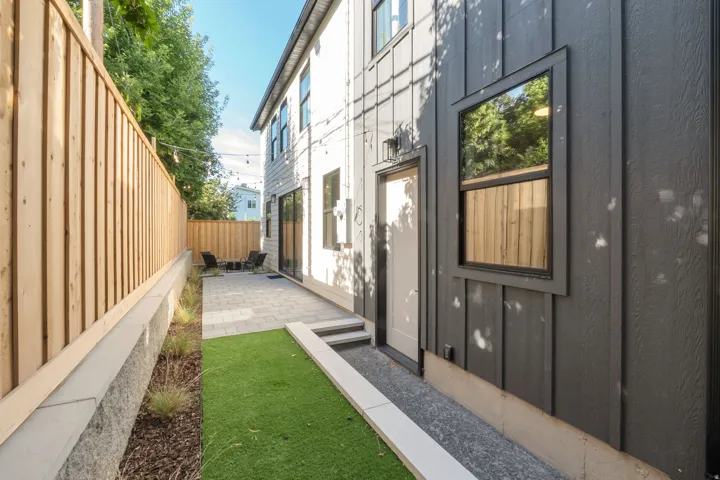 Modern exterior featuring dark vertical siding and a contrasting light entry door
