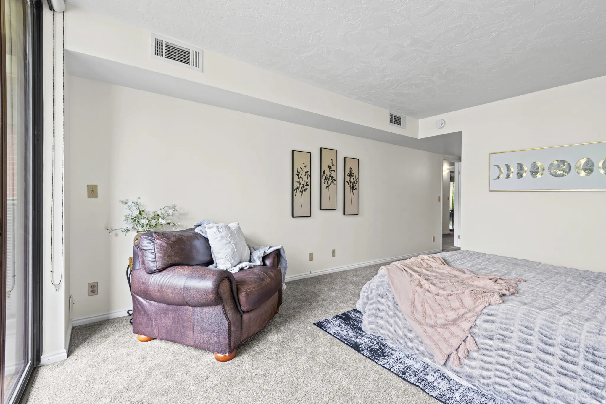 Carpeted room with light-toned walls and white trim