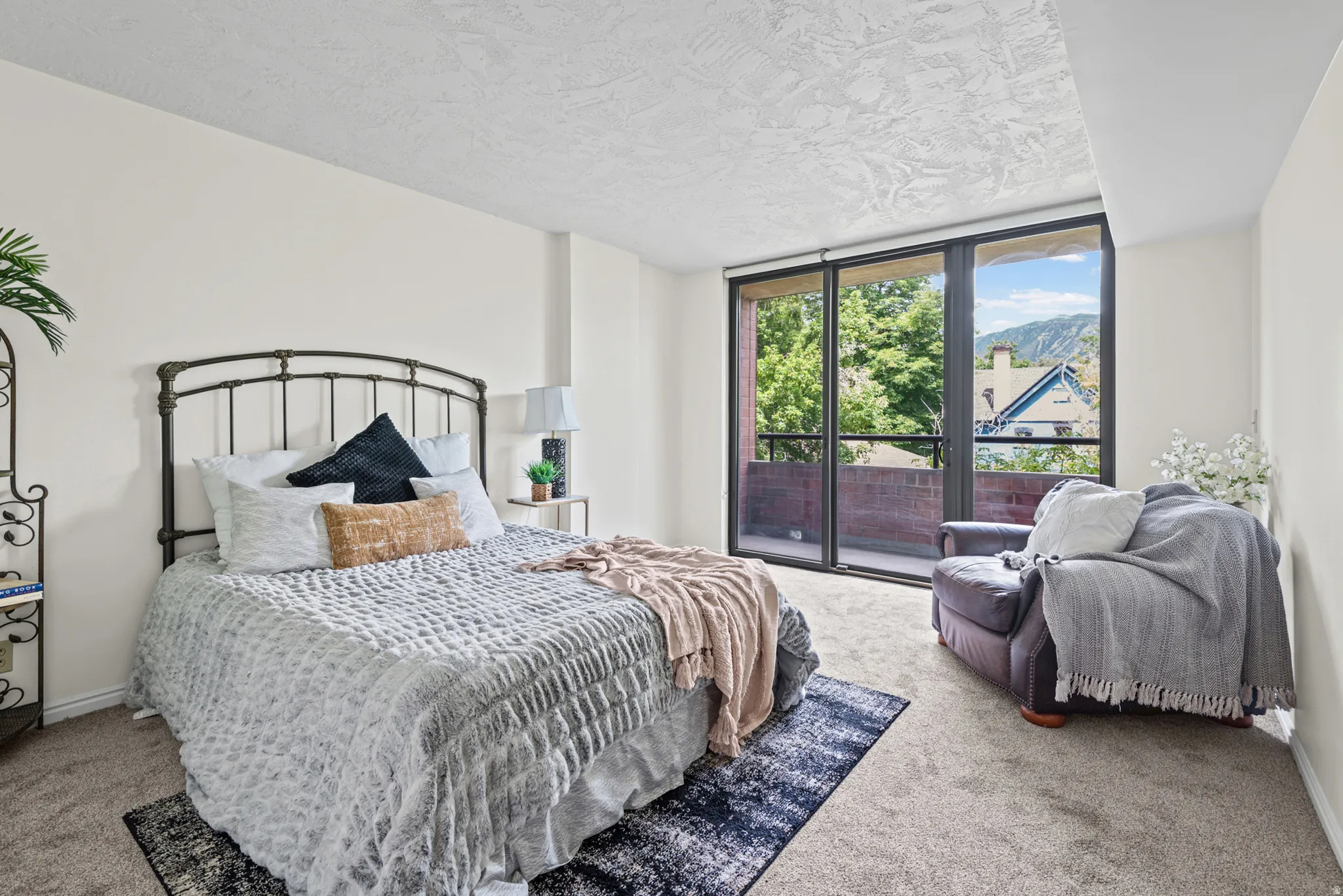 Spacious room featuring a floor-to-ceiling glass sliding door, providing access to a private balcony