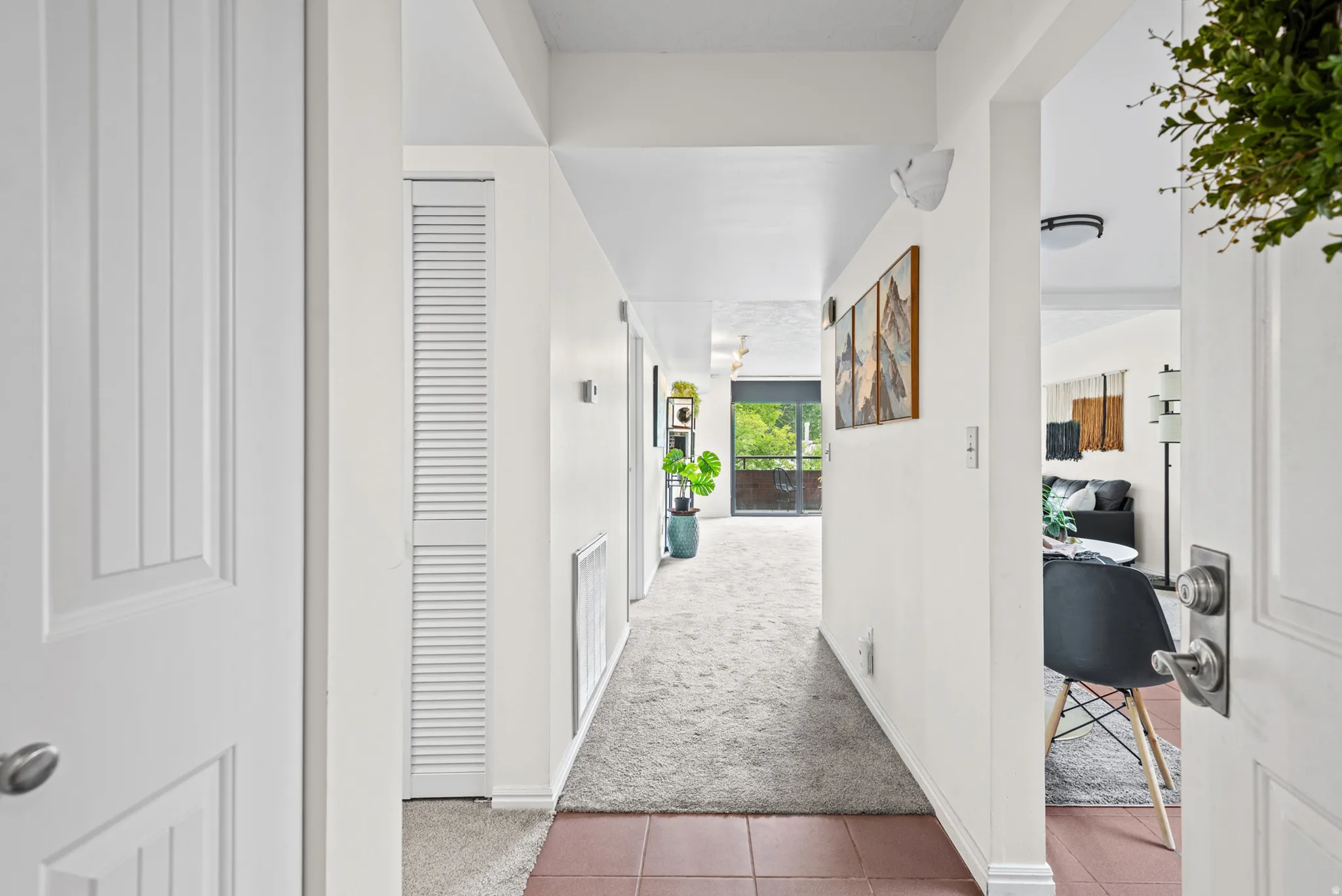 Entryway featuring terracotta-style tile flooring and a louvered closet door