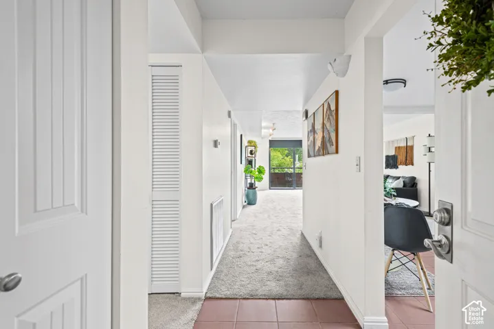 Entryway featuring terracotta-style tile flooring and a louvered closet door