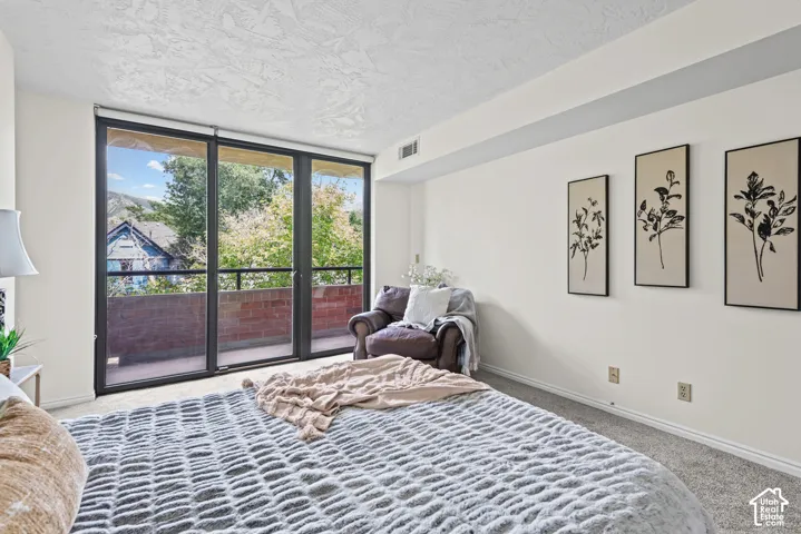 Wall-to-wall sliding glass doors opening to a private balcony
