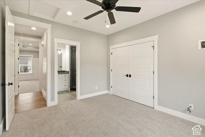 Carpeted room featuring a ceiling fan with light, recessed lighting, and white bi-fold closet doors with black hardware