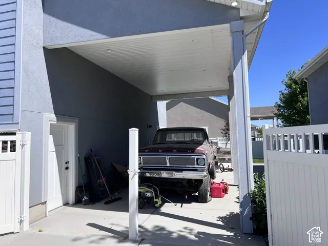 Carport featuring an open-air design, recessed lighting, and a durable concrete surface