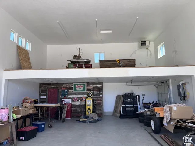 Spacious garage with a finished concrete floor and a full-width loft level