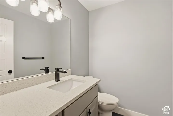 Bathroom featuring a neutral color palette, integrated sink, and dark bronze fixtures