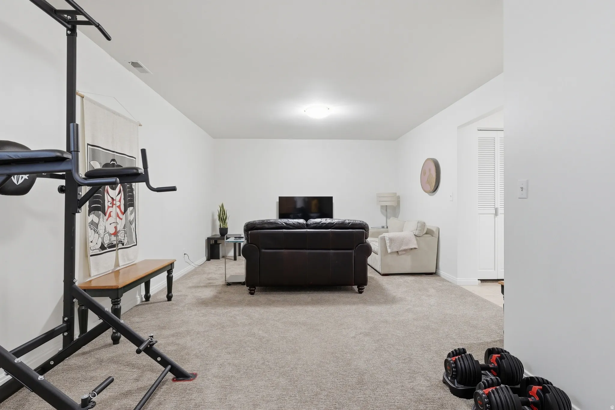 Open concept room combining a family room and a bedroom that could be separated or left open for the occasional guest.