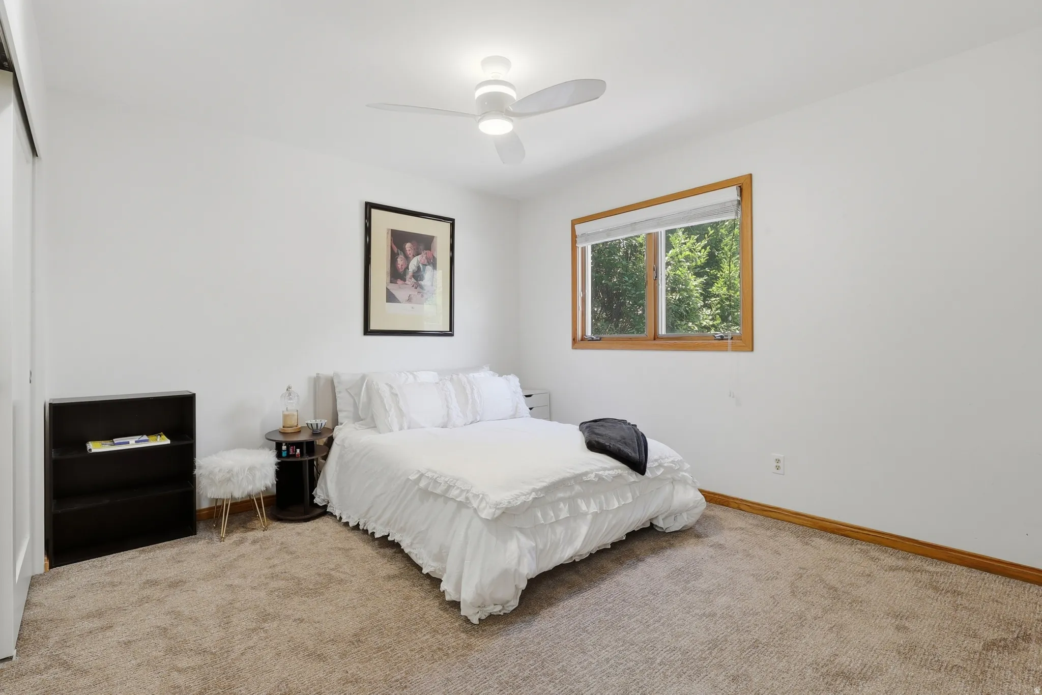 Bedroom #3 features a ceiling fan with integrated lighting, a wood-trimmed window, white window blinds, and ample closet space.