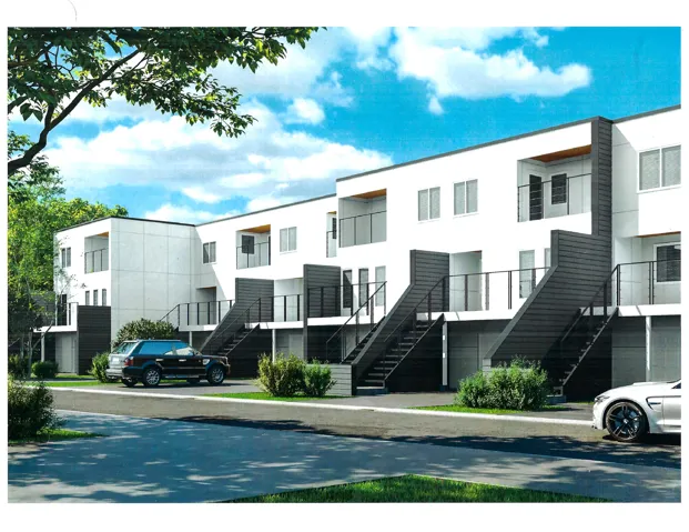 Modern townhouse complex featuring clean lines and a white facade