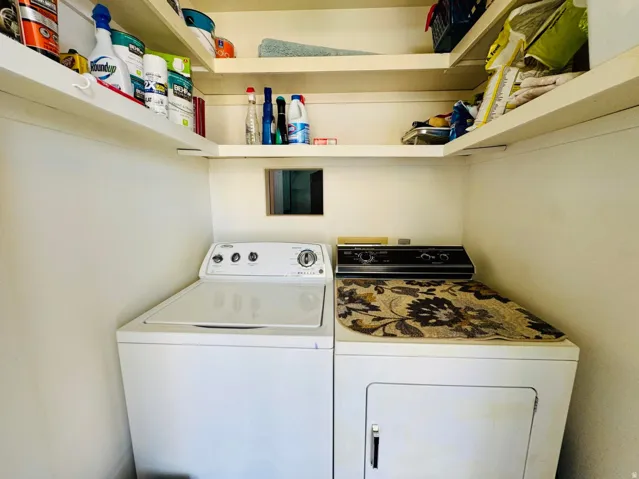Dedicated laundry area featuring a built-in washing machine and dryer