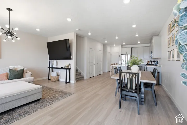 Open-concept main living area with wood-finish flooring throughout