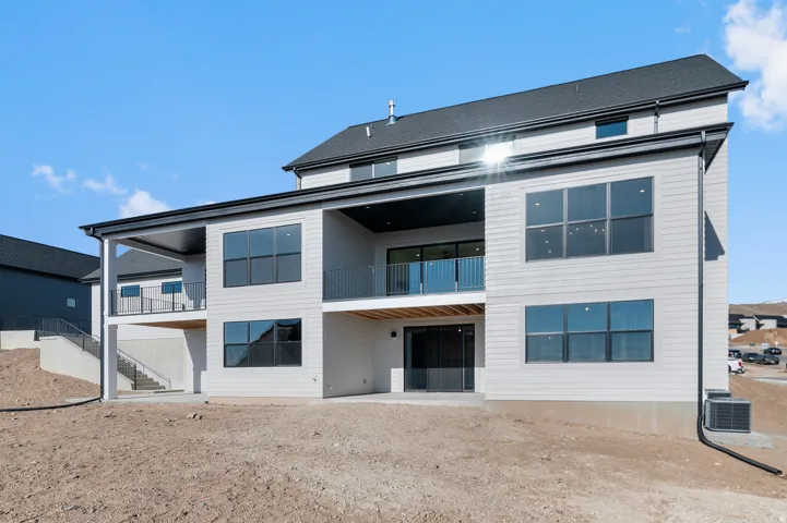 Modern multi-level exterior with light-colored siding and dark trim