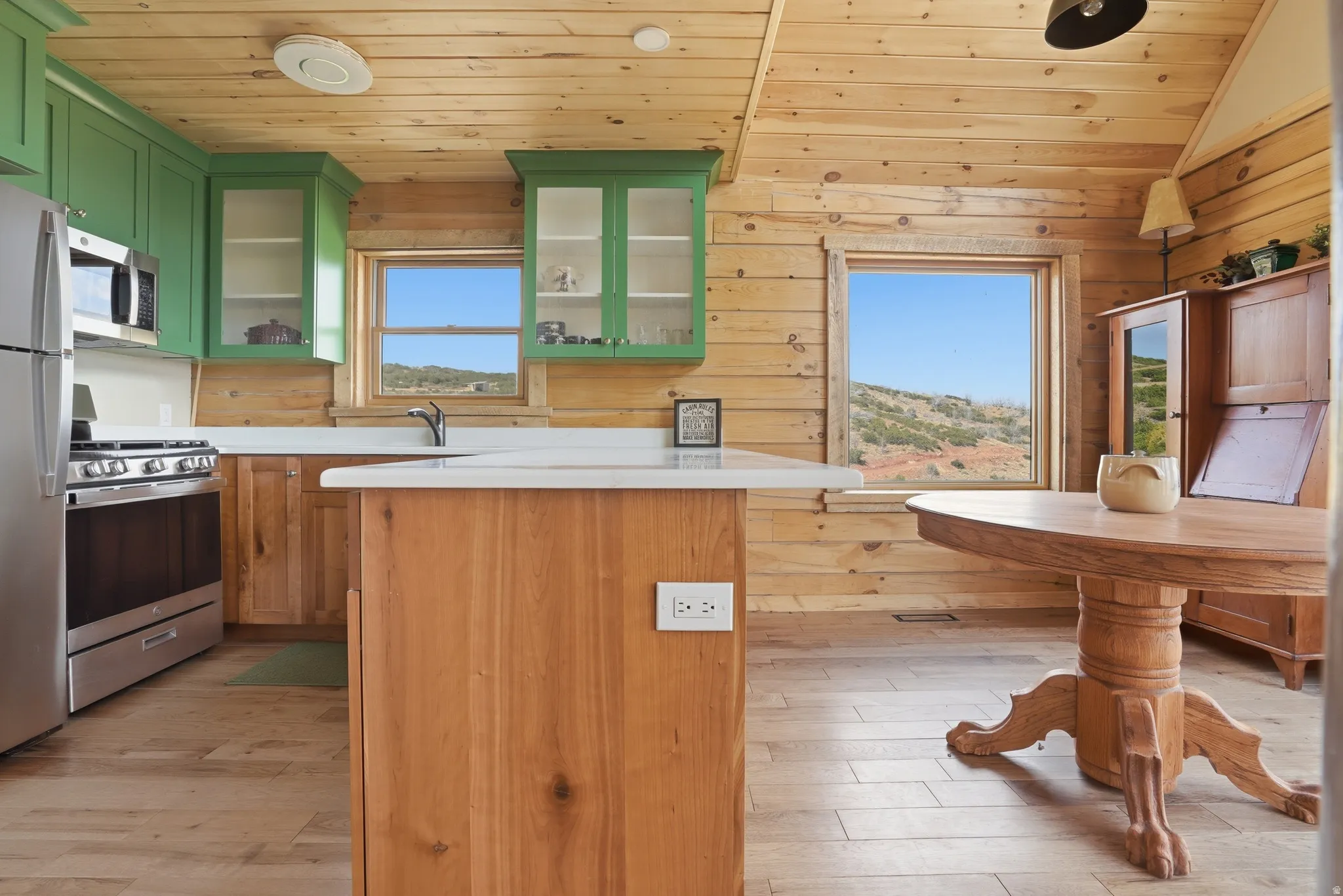 Kitchen featuring light wood-finish flooring and solid wood walls