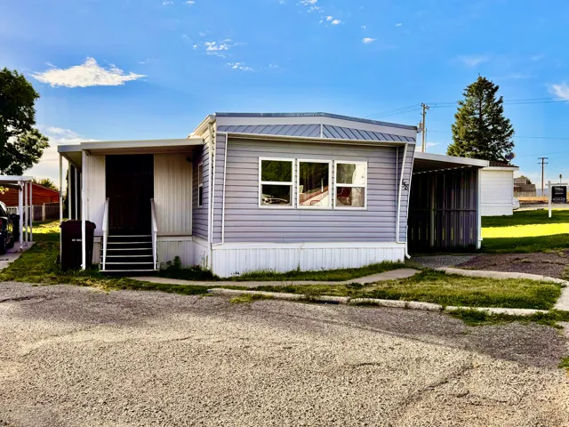 Manufactured home with light blue siding and white trim