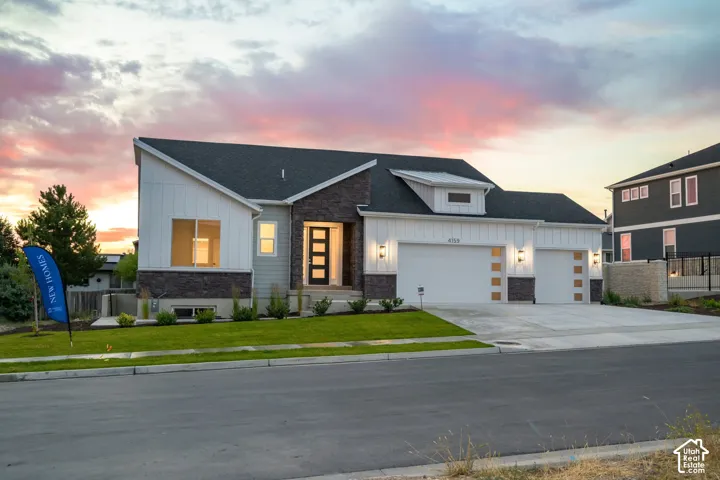 Modern architectural facade featuring mixed materials, a dark-toned roof, and white vertical siding