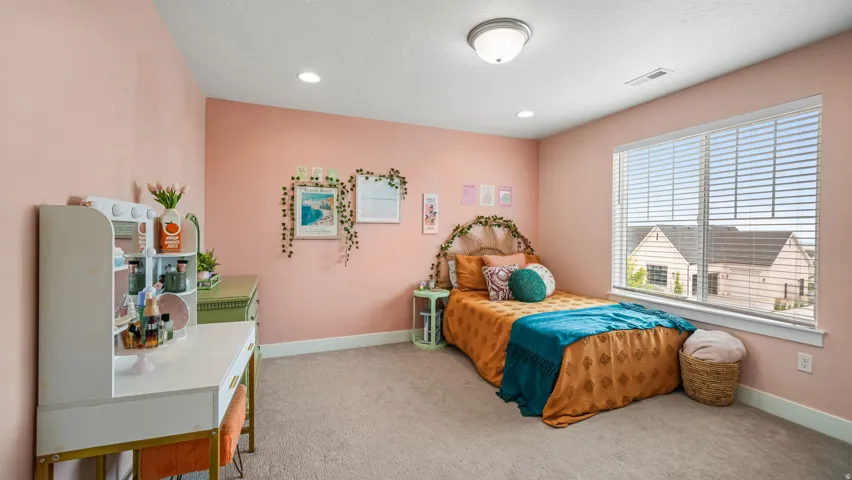 Room featuring pale pink walls, recessed lighting, and a large window with white blinds