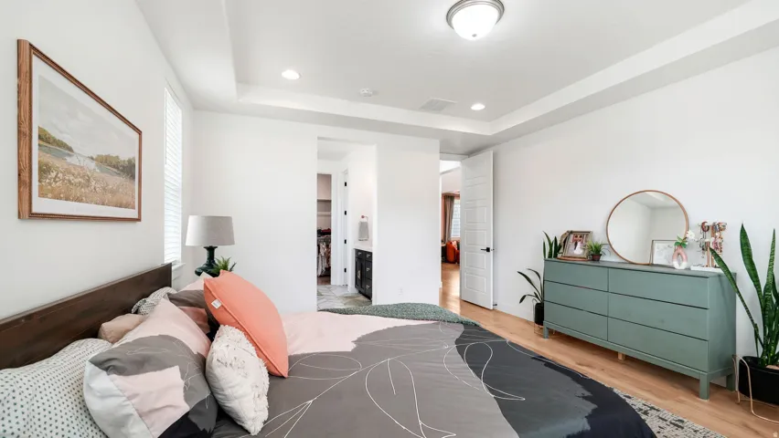 Tray ceiling with recessed lighting and a central dome light fixture