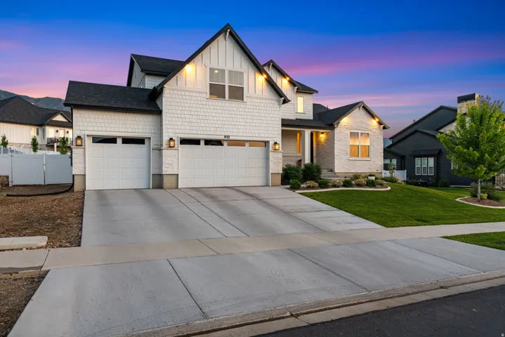 Contemporary two-story residence featuring a combination of white shaker siding and light-toned brick accents