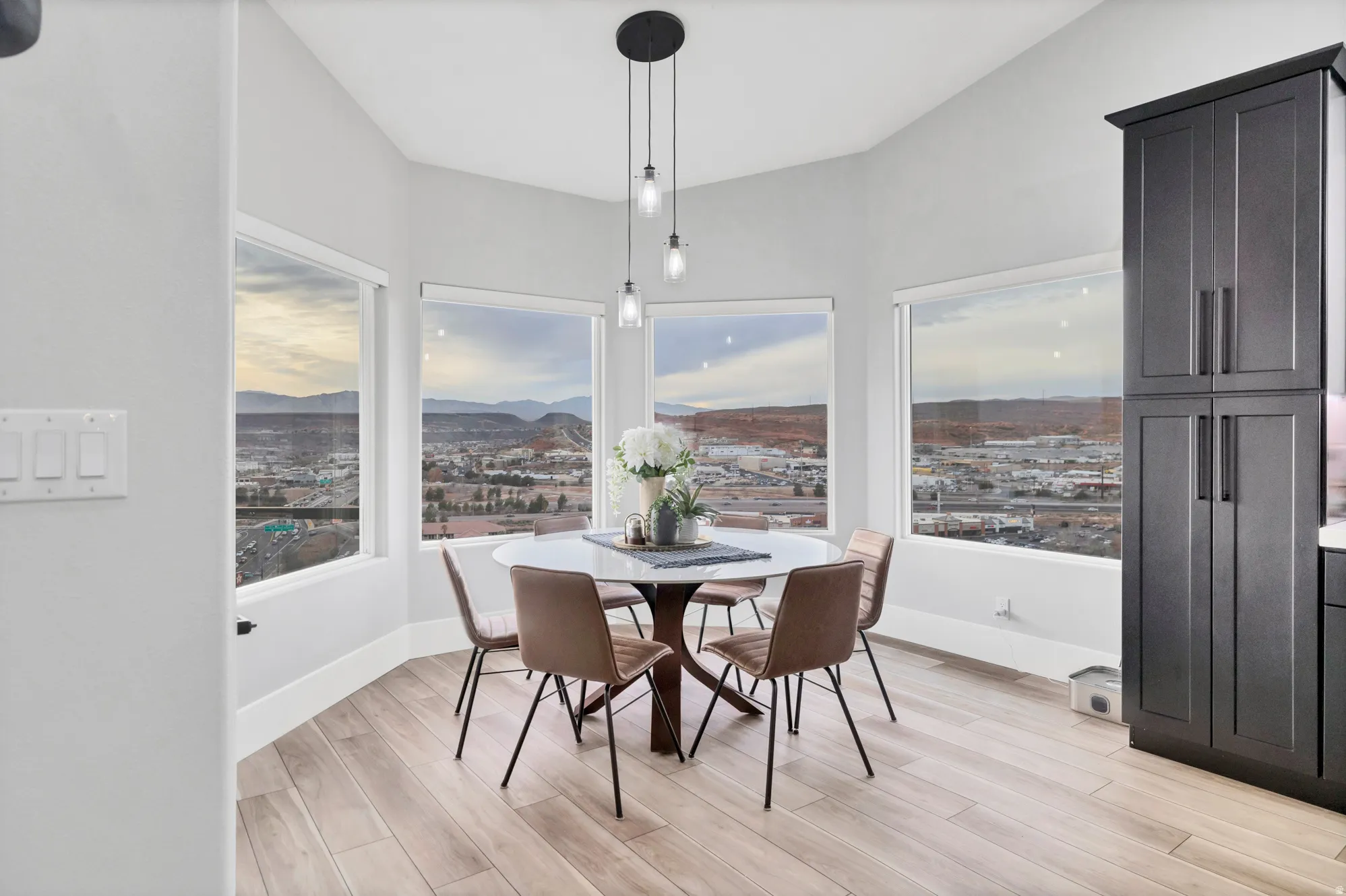 Dining area featuring multiple windows, recessed lighting, and wood-finish flooring