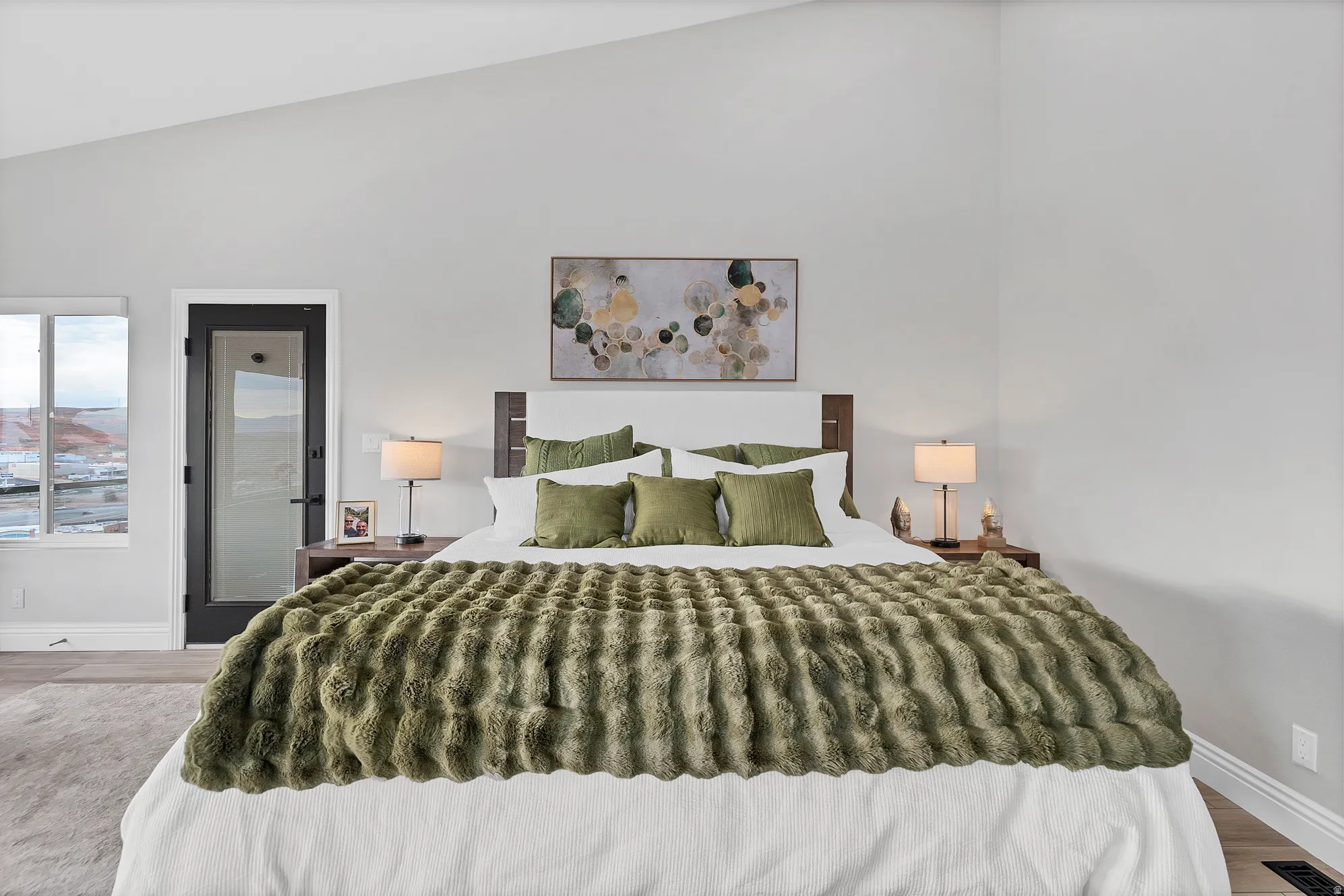 Bedroom featuring a vaulted ceiling and light-toned walls