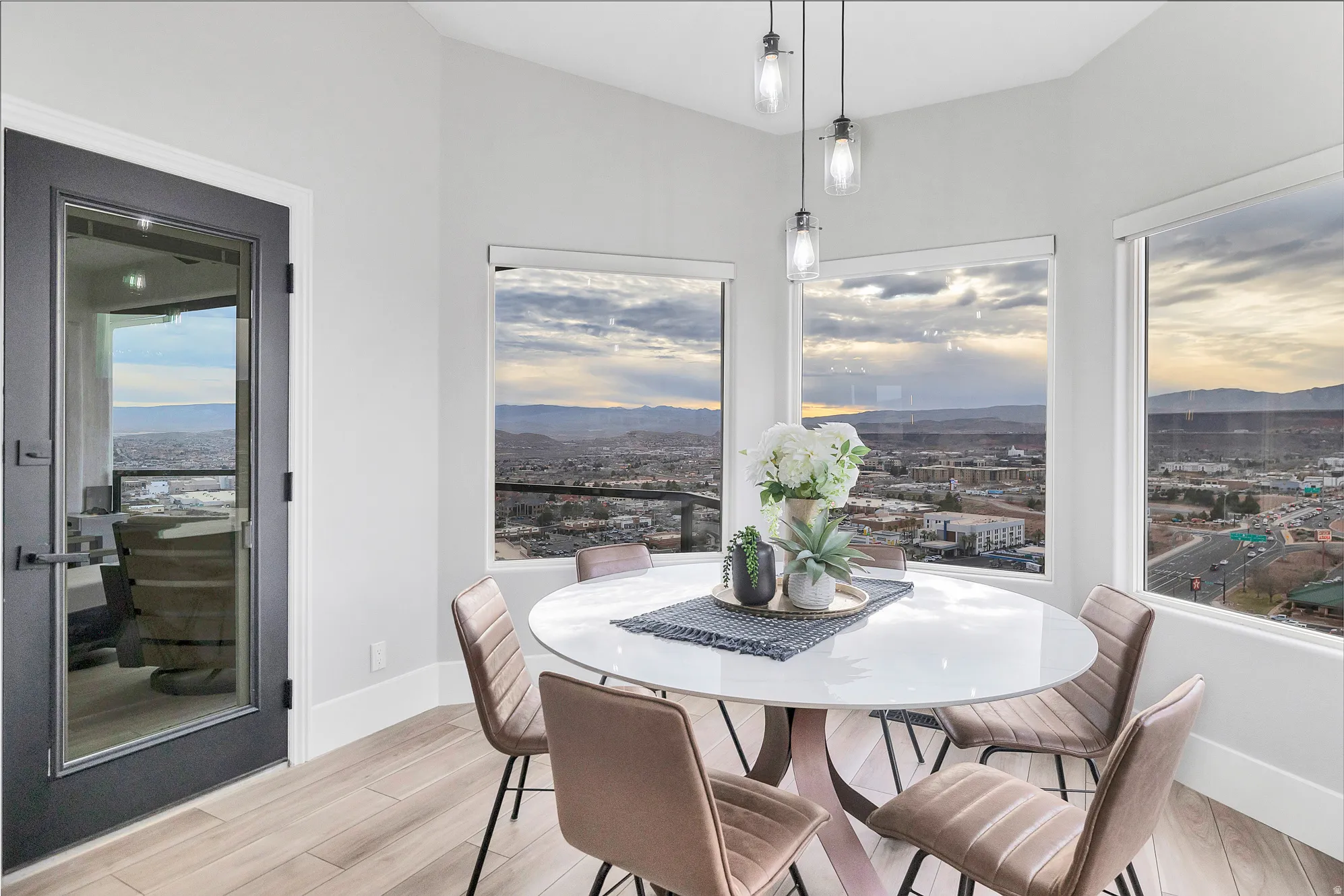 Bay window dining area with city and mountain scenery