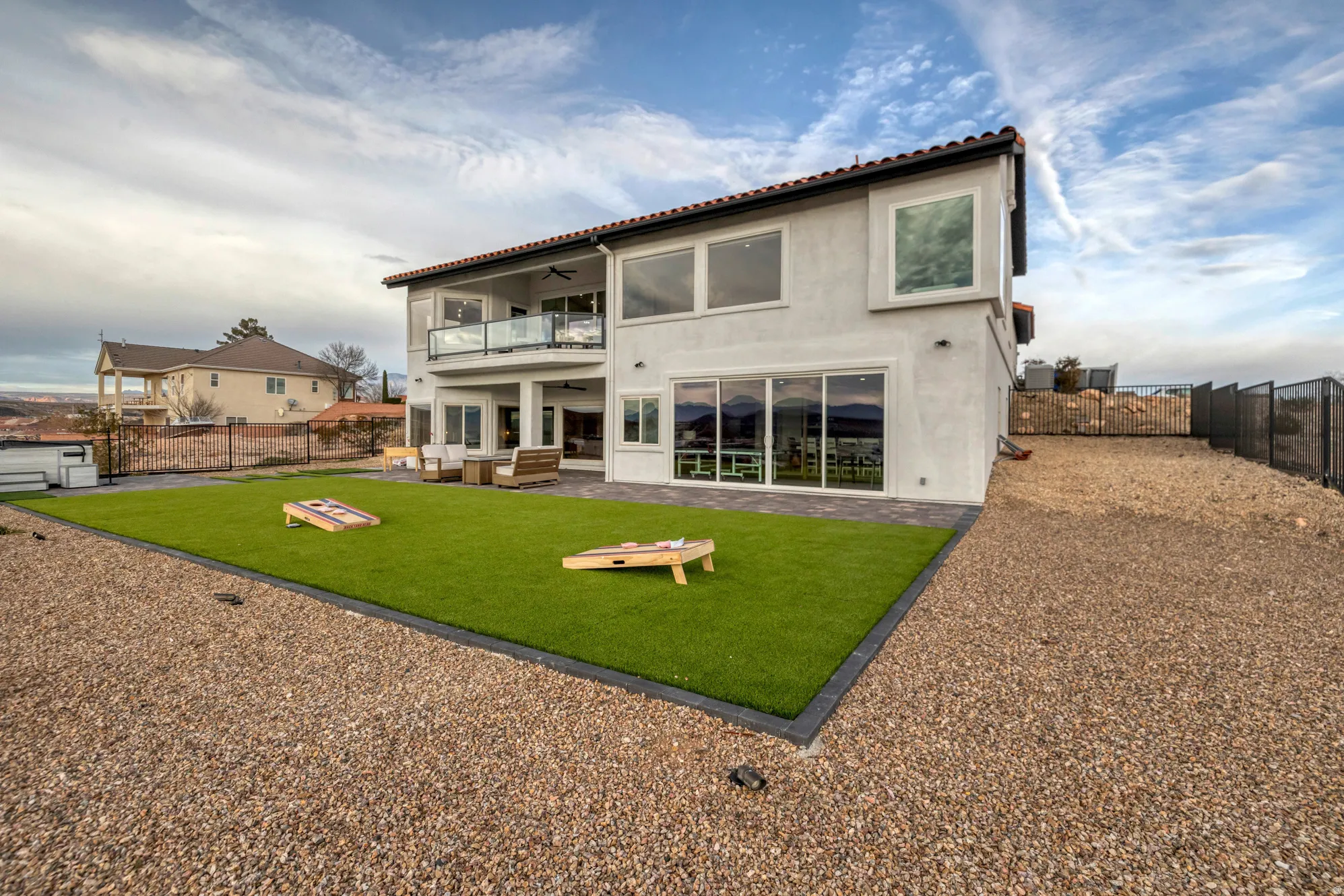 Rear exterior featuring a stone tile roof and stucco siding