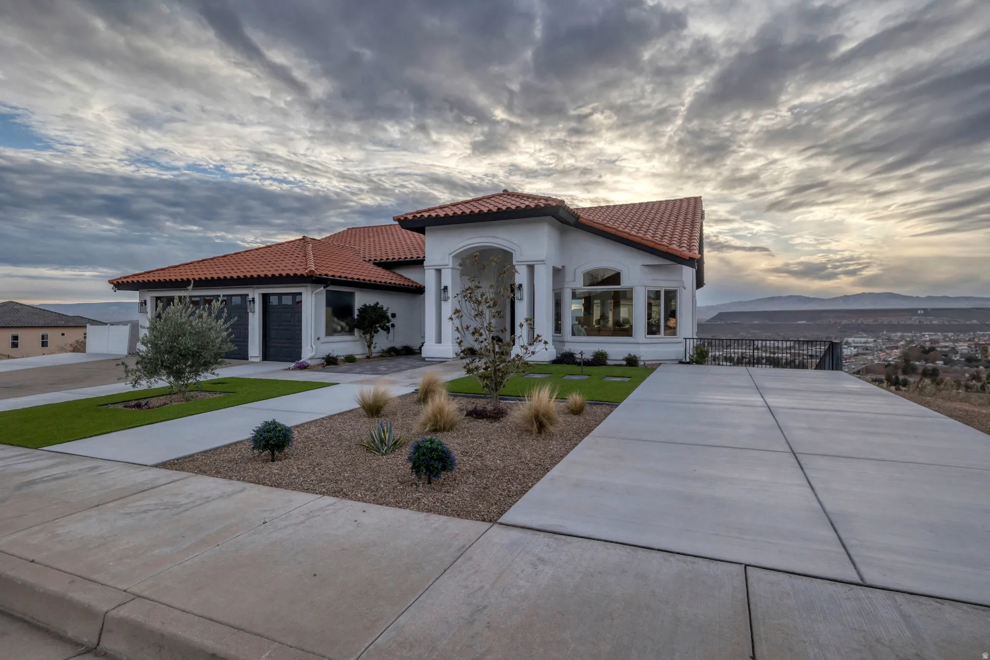 Mediterranean-style residence featuring a tile roof, white stucco exterior, and multi-pane windows
