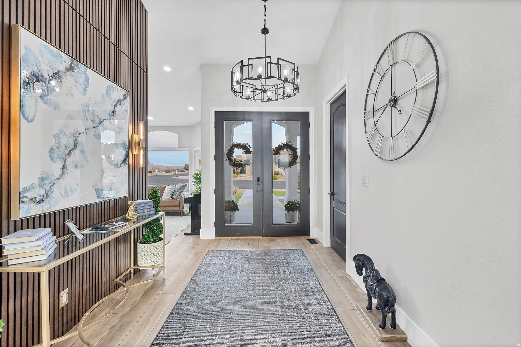 Spacious entryway featuring light wood-finish flooring and a prominent decorative wood-slat accent wall