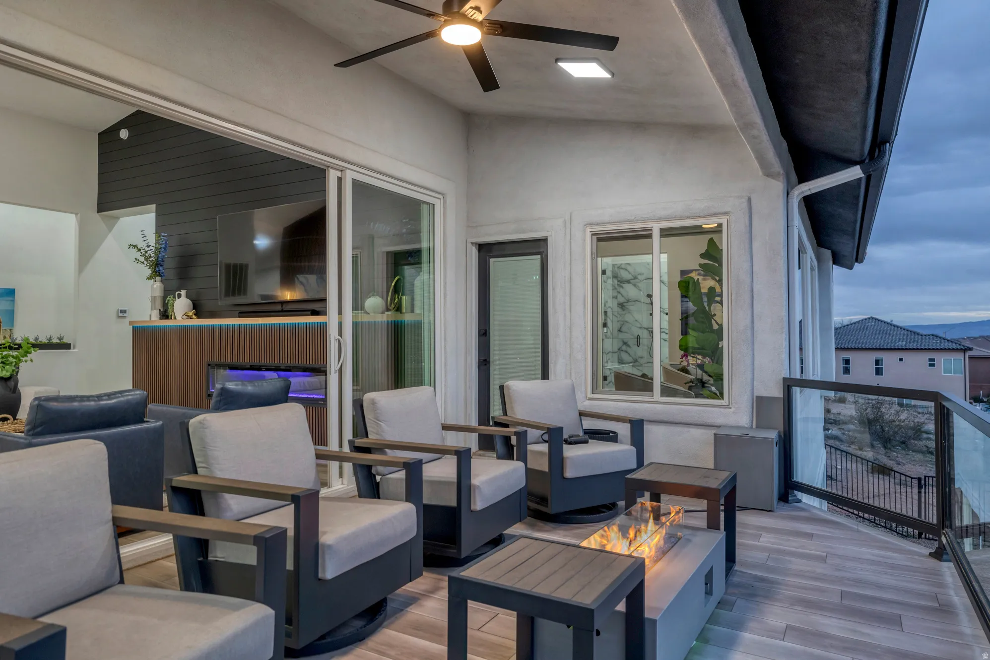 Outdoor living space featuring a ceiling fan, recessed lighting, and wood-finish flooring