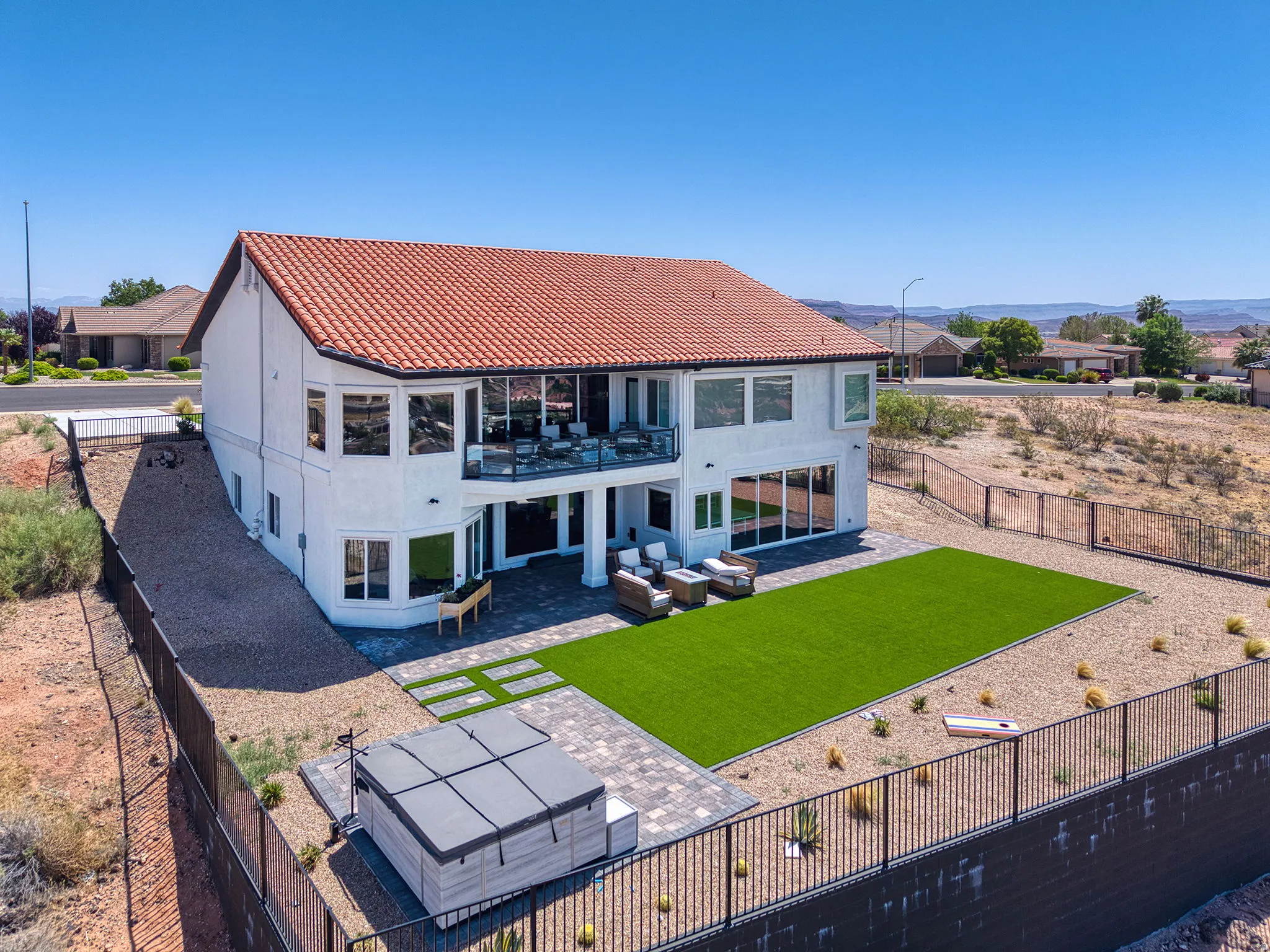 Mediterranean-style residence featuring a terracotta tile roof and white stucco exterior
