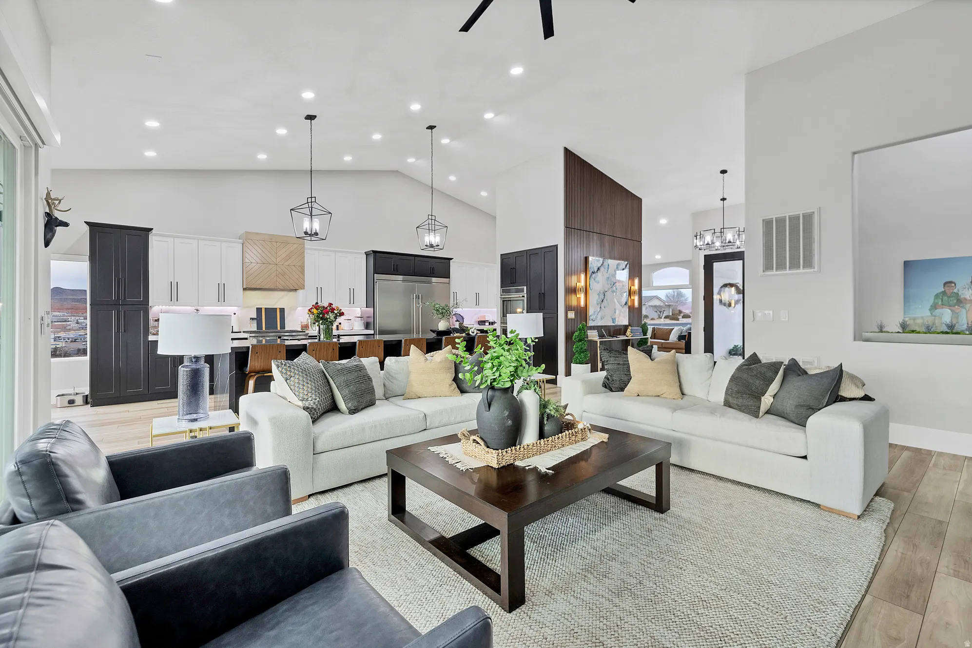 Vaulted ceiling great room featuring wood-finish flooring and recessed lighting