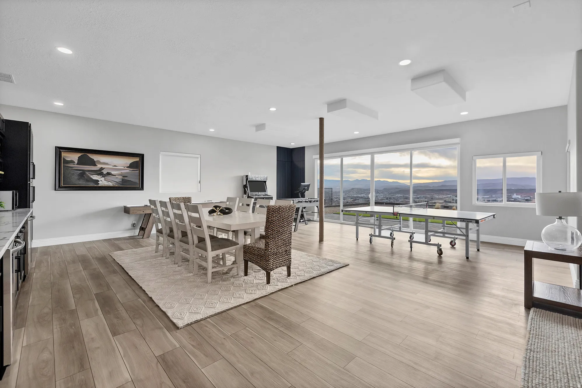 Spacious room featuring wood-finish flooring, recessed lighting, and large windows