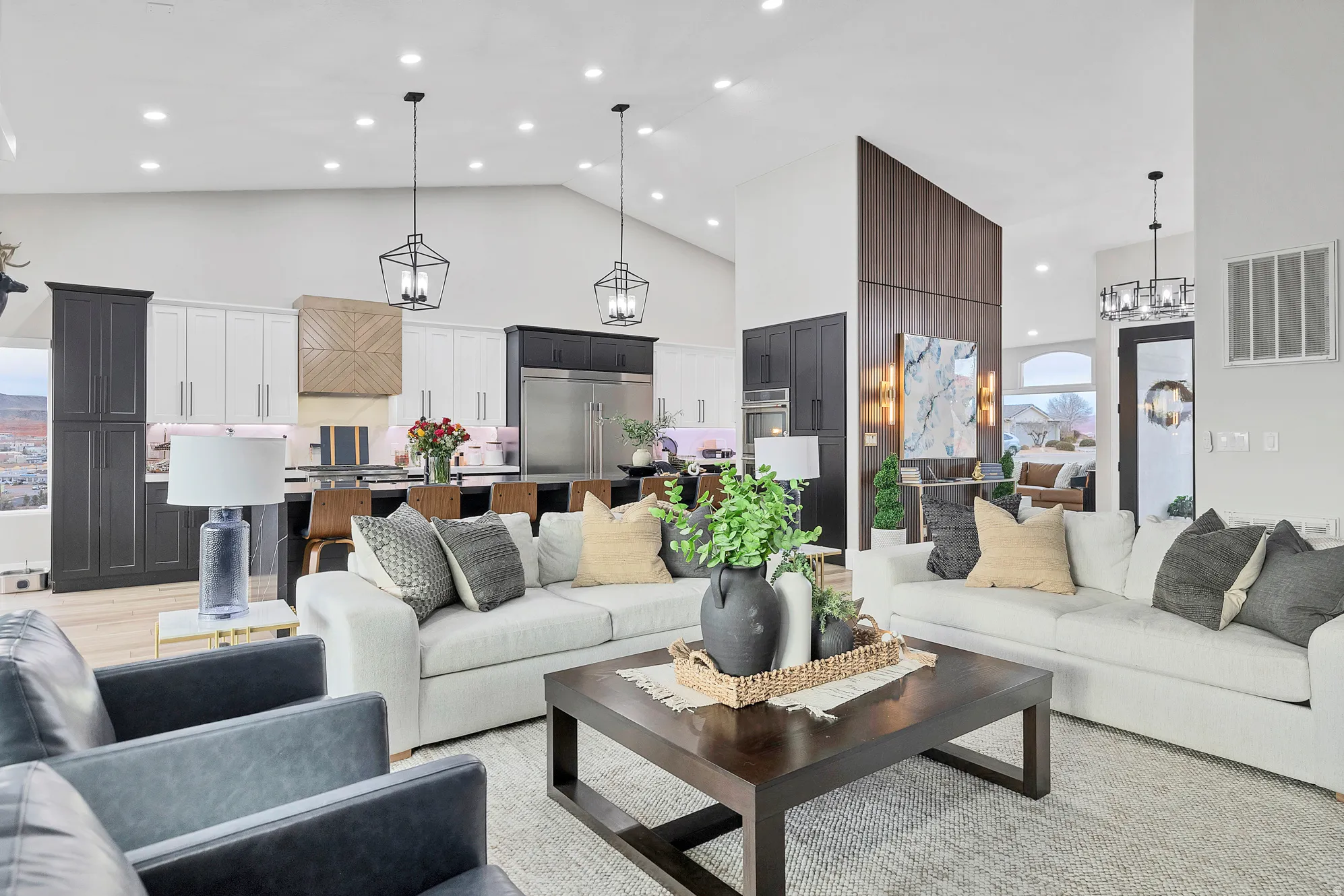 Spacious living area featuring vaulted ceilings, recessed lighting, and wood-finish flooring