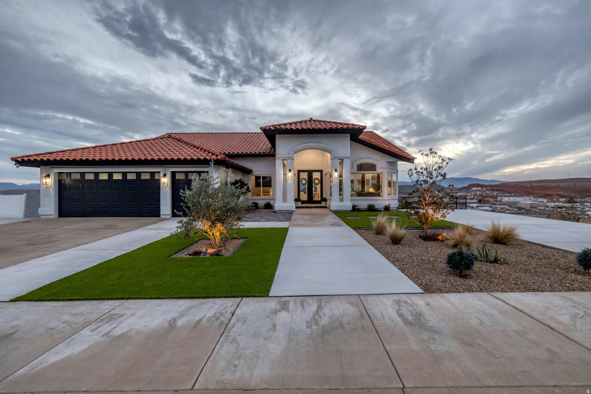 Mediterranean-style exterior featuring a red tile roof and white stucco facade