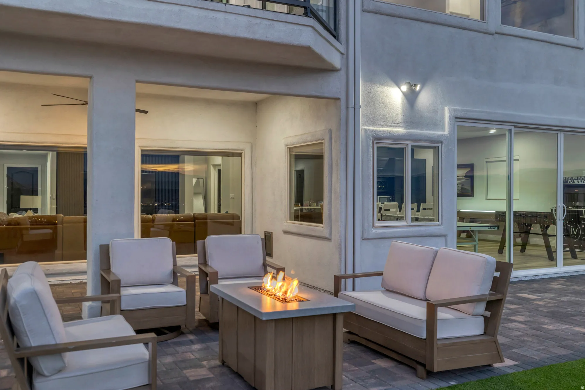 Expansive outdoor patio featuring paver flooring and a gas fire pit