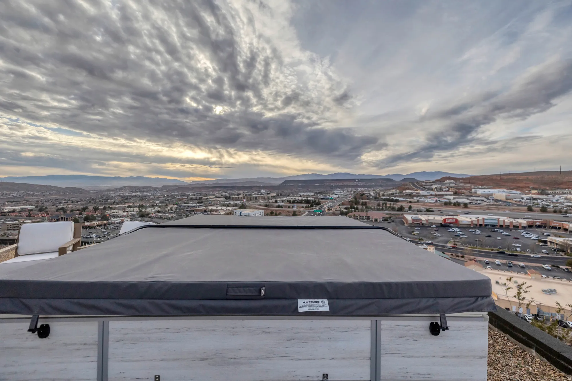 Rooftop spa with a protective cover and wood-finish paneling
