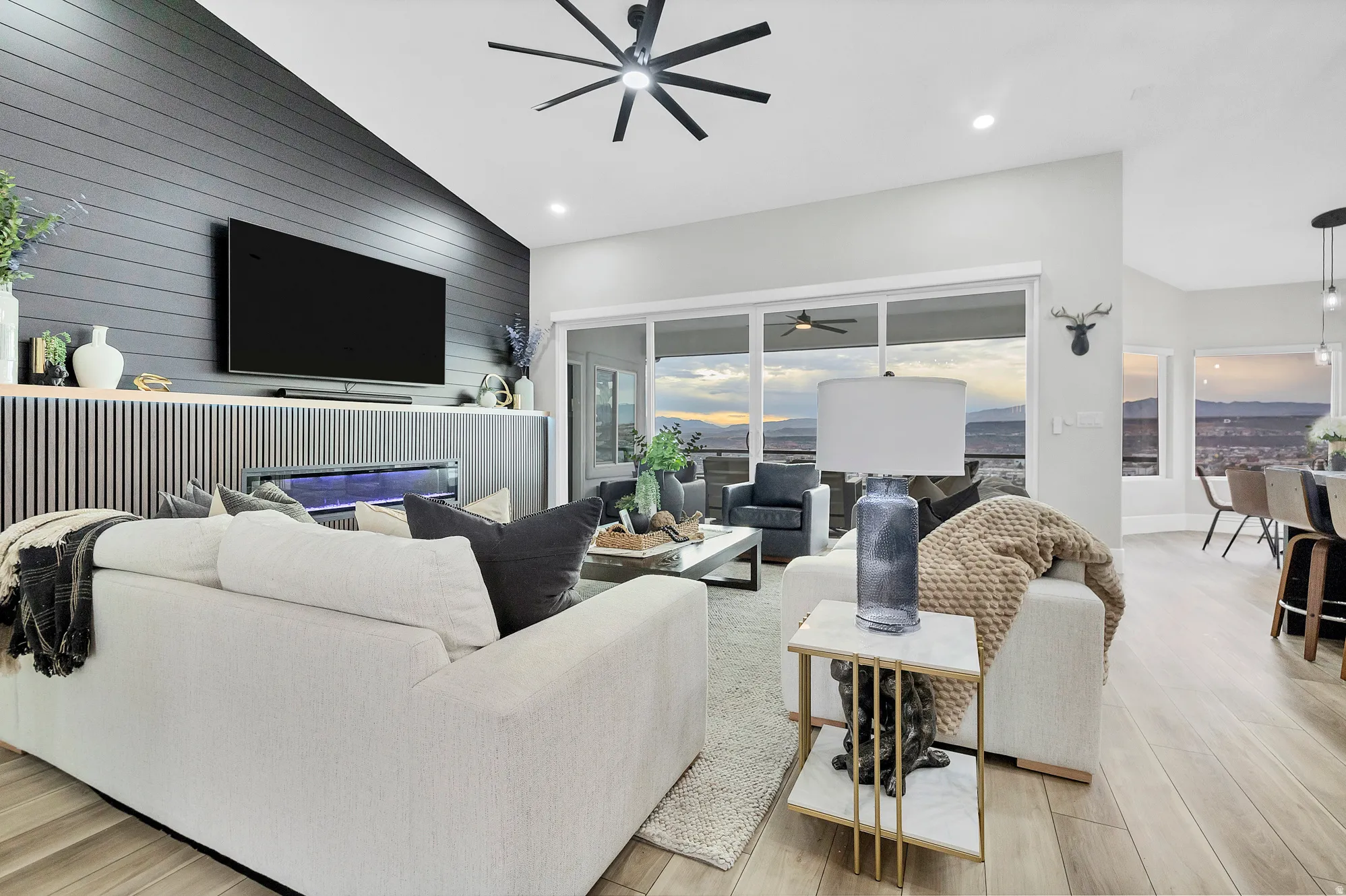 Living area featuring a vaulted ceiling with a modern ceiling fan, recessed lighting, and wood-finish flooring