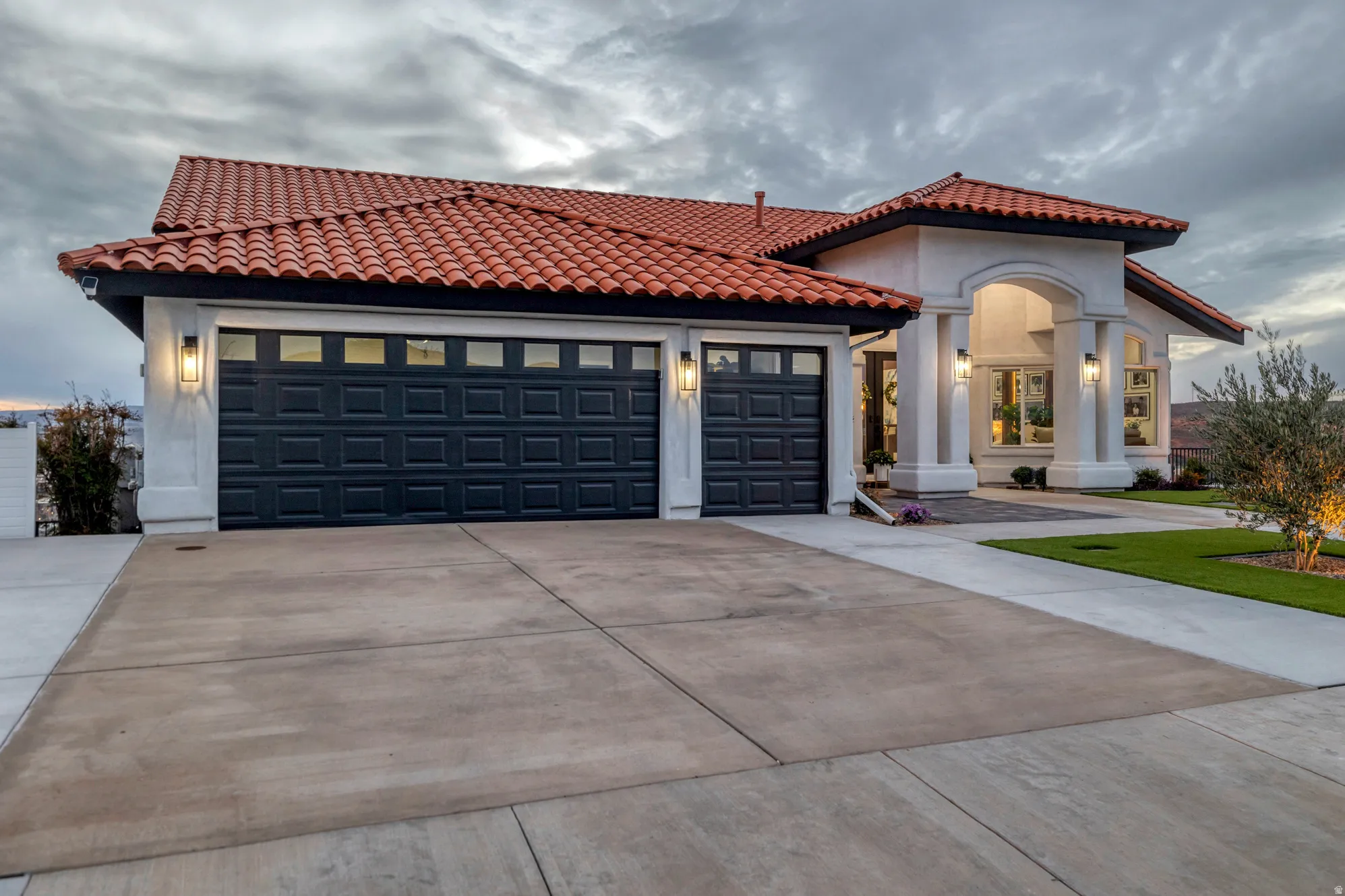 Contemporary stucco exterior with a terra cotta tile roof