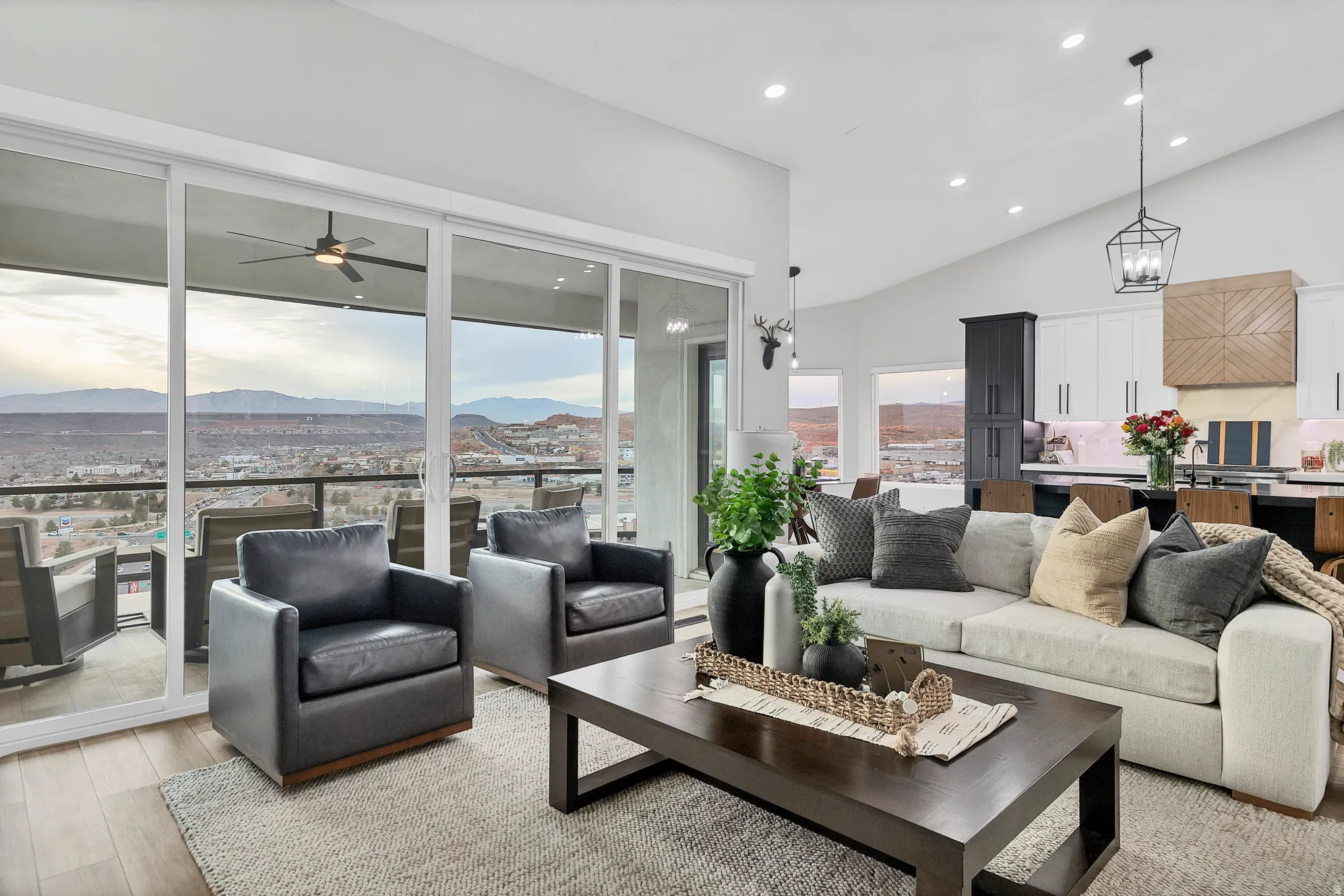Spacious living area featuring expansive glass sliding doors opening to an outdoor patio with mountain scenery