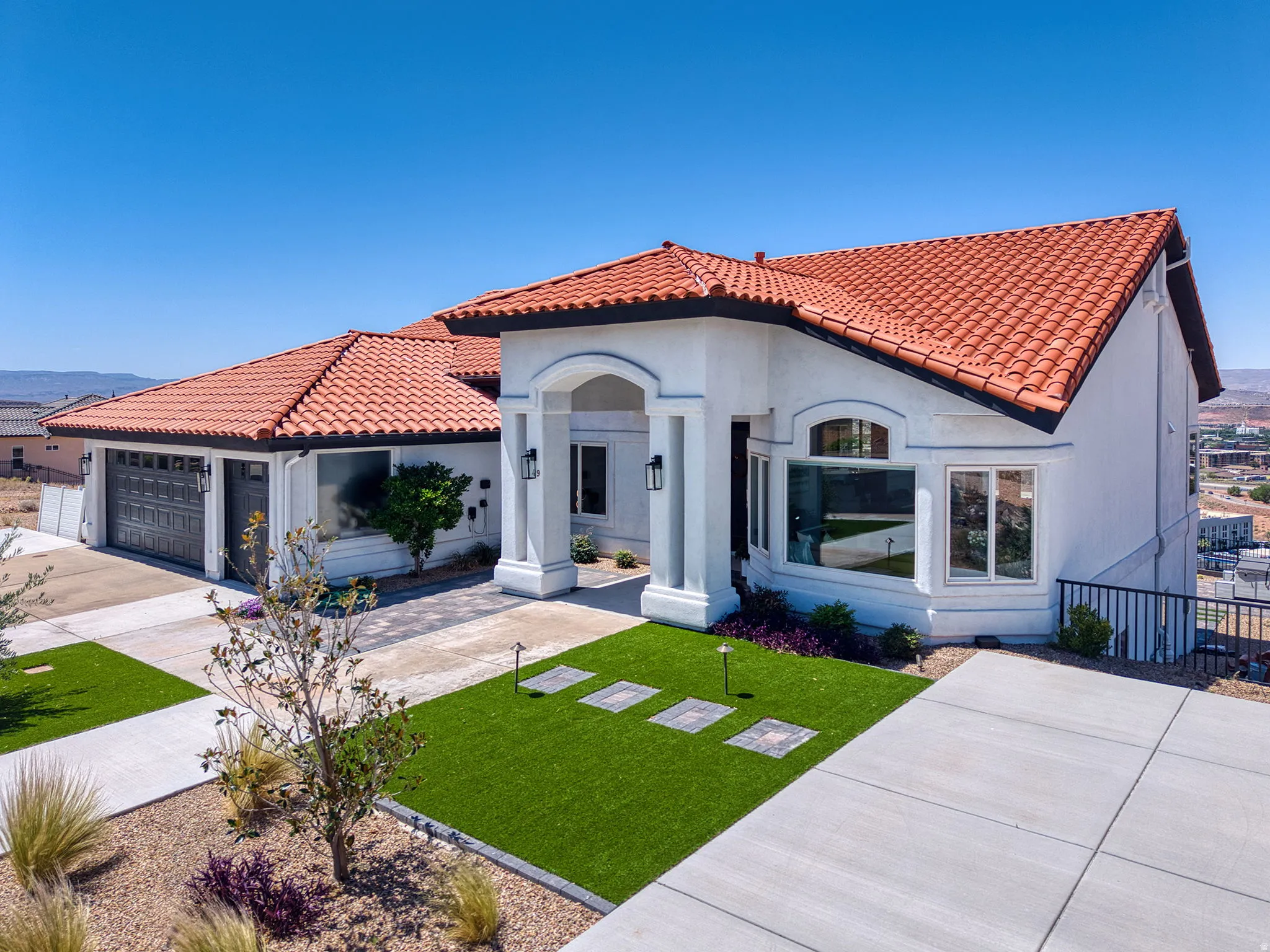 White stucco exterior with a terra cotta tile roof