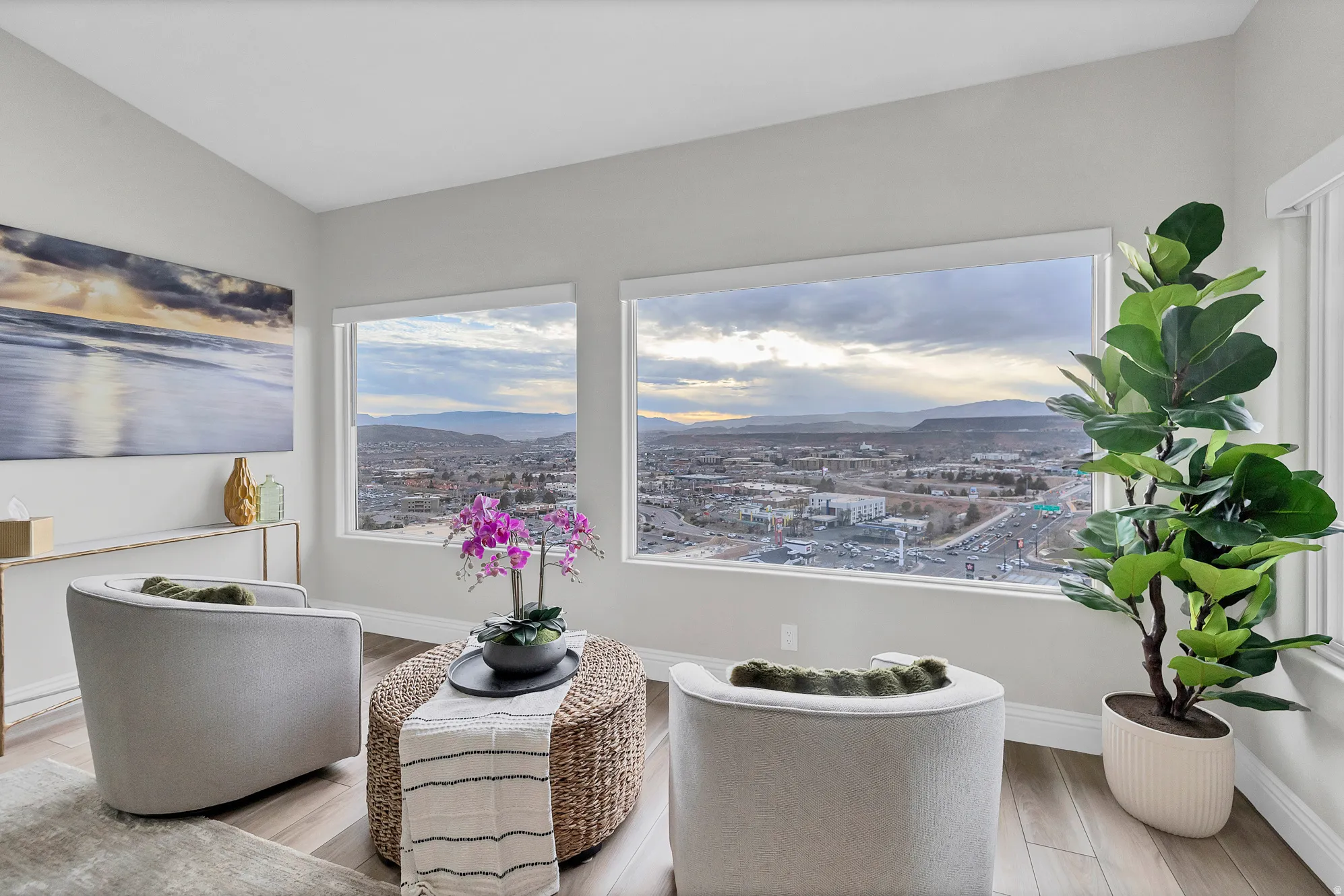 Expansive windows framing distant mountains and an urban landscape