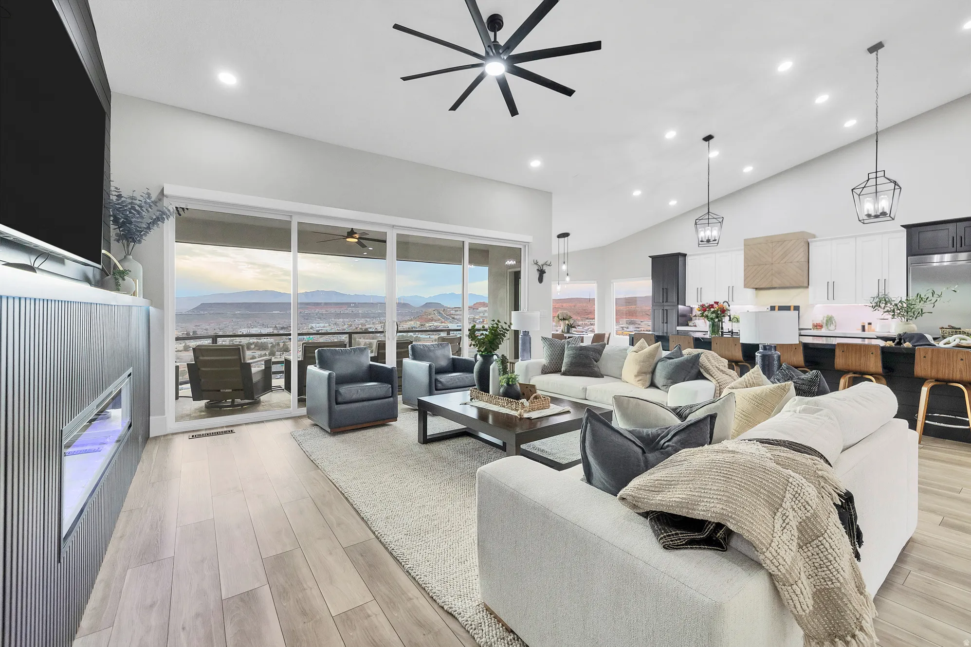 Open-concept living area with vaulted ceilings, recessed lighting, and light wood-finish flooring