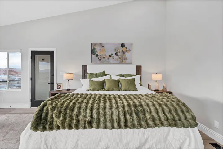 Bedroom featuring a vaulted ceiling and light-toned walls