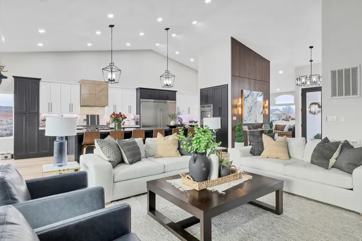 Spacious living area featuring vaulted ceilings, recessed lighting, and wood-finish flooring