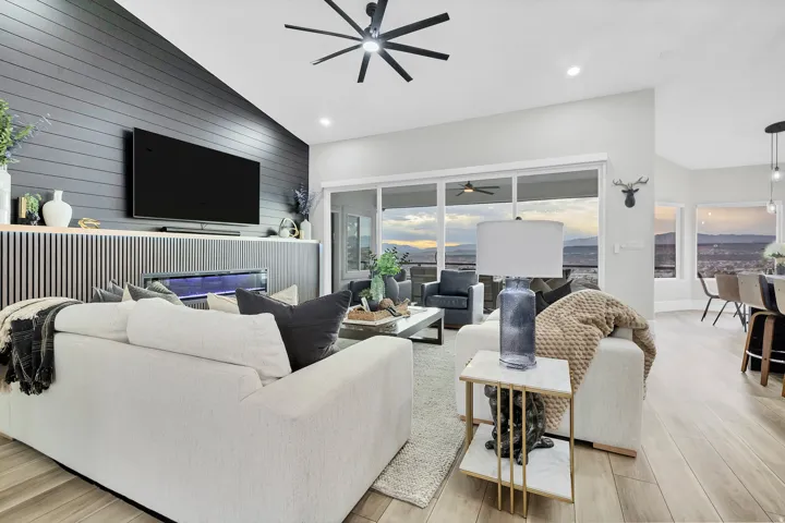 Living area featuring a vaulted ceiling with a modern ceiling fan, recessed lighting, and wood-finish flooring