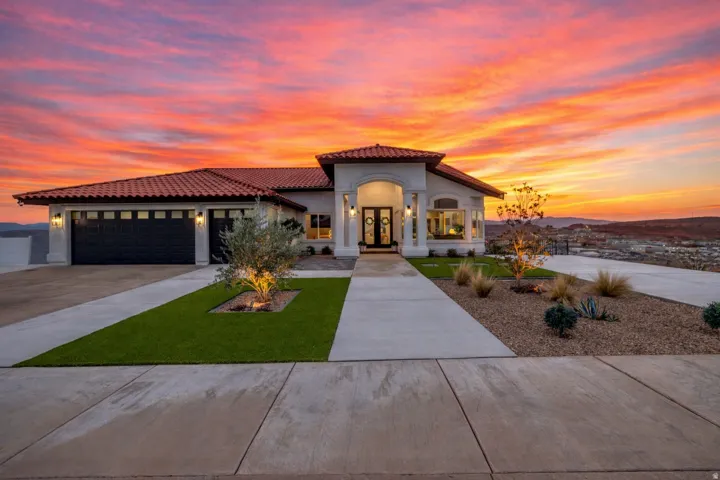 Mediterranean-style residence featuring a terracotta tile roof and stucco exterior