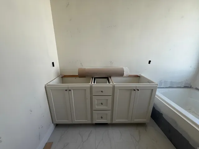 Double vanity base with shaker-style cabinetry and brushed nickel hardware