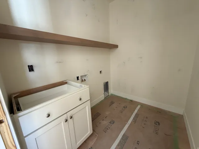 Built-in white cabinetry with brushed nickel hardware and an integrated sink basin
