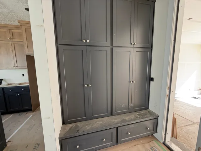 Built-in cabinetry with a dark finish and a seated bench